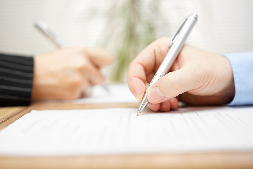 43132464 - man and woman writing on document