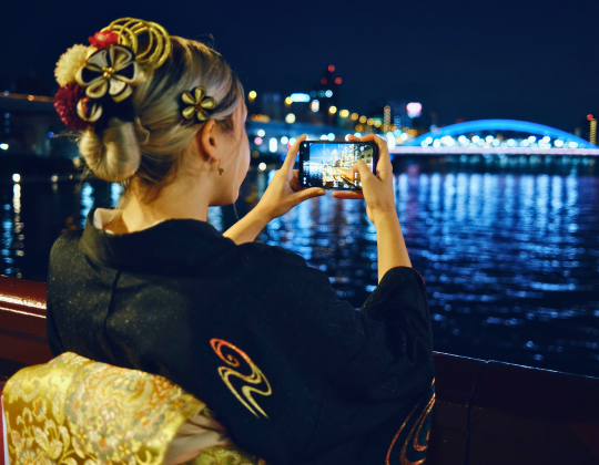 foreign tourist taking a picture while wearing kimono