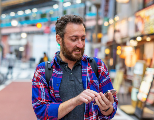 man using his cell phone in japan