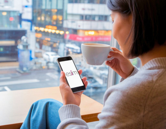 a woman using her phone at a cafe in japan