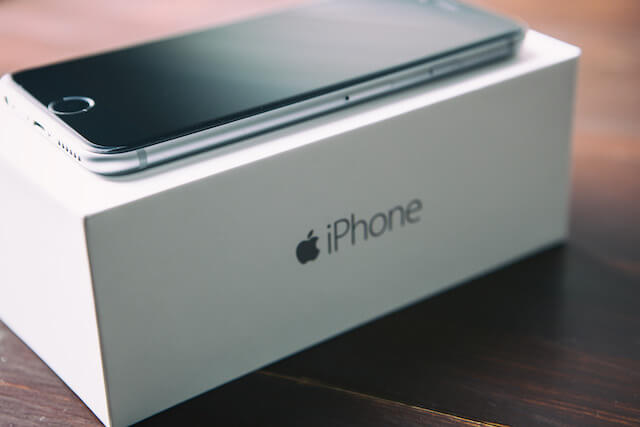 iPhone resting on top of its box