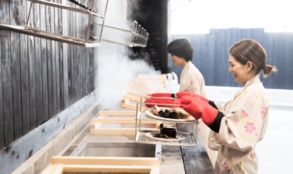 Two women steaming food at Hyotan Onsen